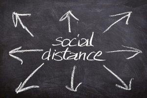 Social distance” written on a board